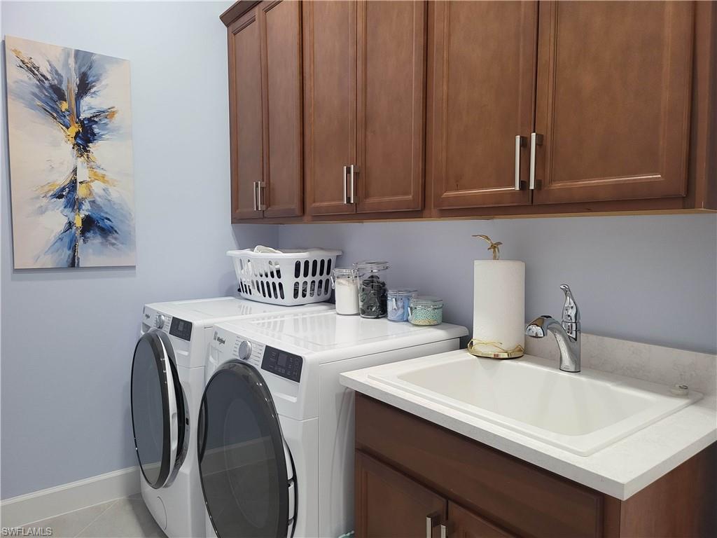 8920 Calypso Court Naples, FL 34113 - Photo 20 of 41 a utility room with dryer and washer