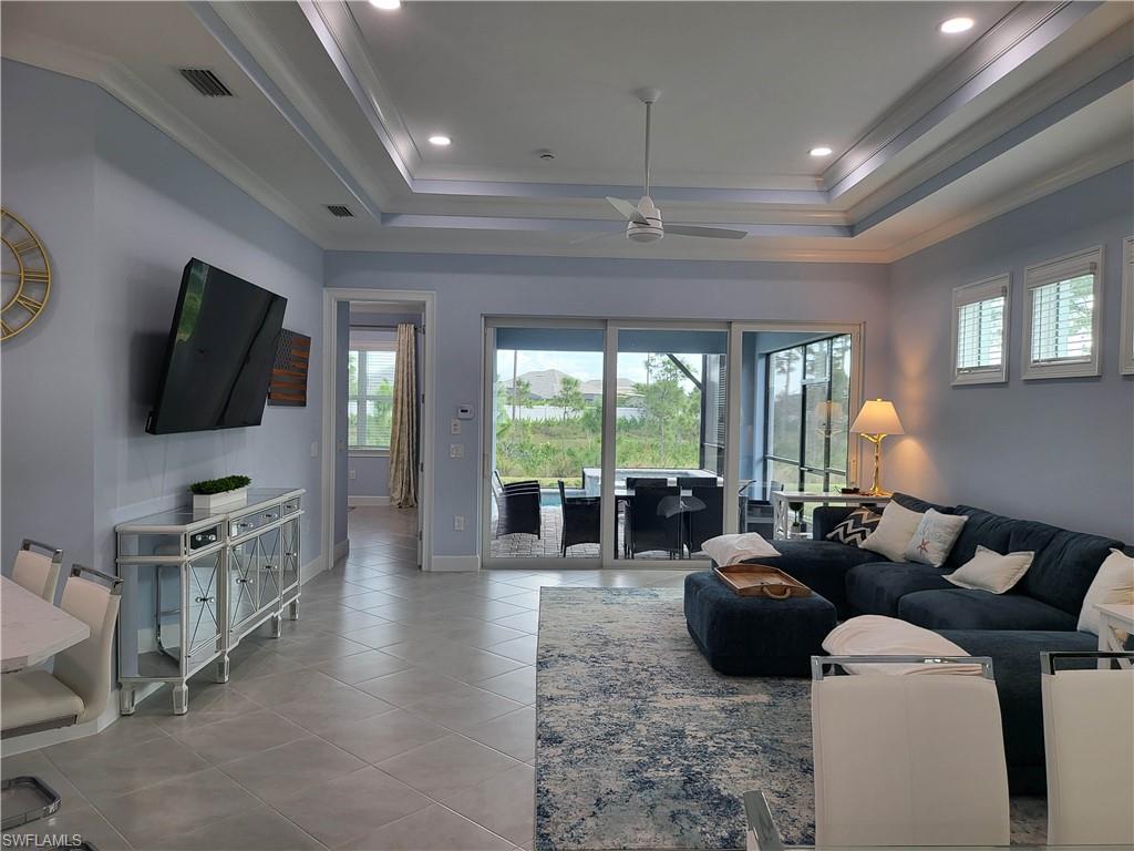 8920 Calypso Court Naples, FL 34113 - Photo 3 of 41 a living room with furniture and a flat screen tv