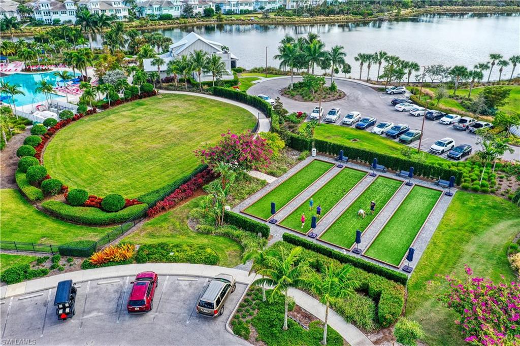8920 Calypso Court Naples, FL 34113 - Photo 34 of 41 a view of a swimming pool with a patio and a garden