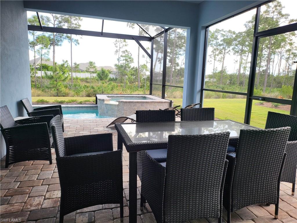 8920 Calypso Court Naples, FL 34113 - Photo 4 of 41 a view of a dining room with furniture and window