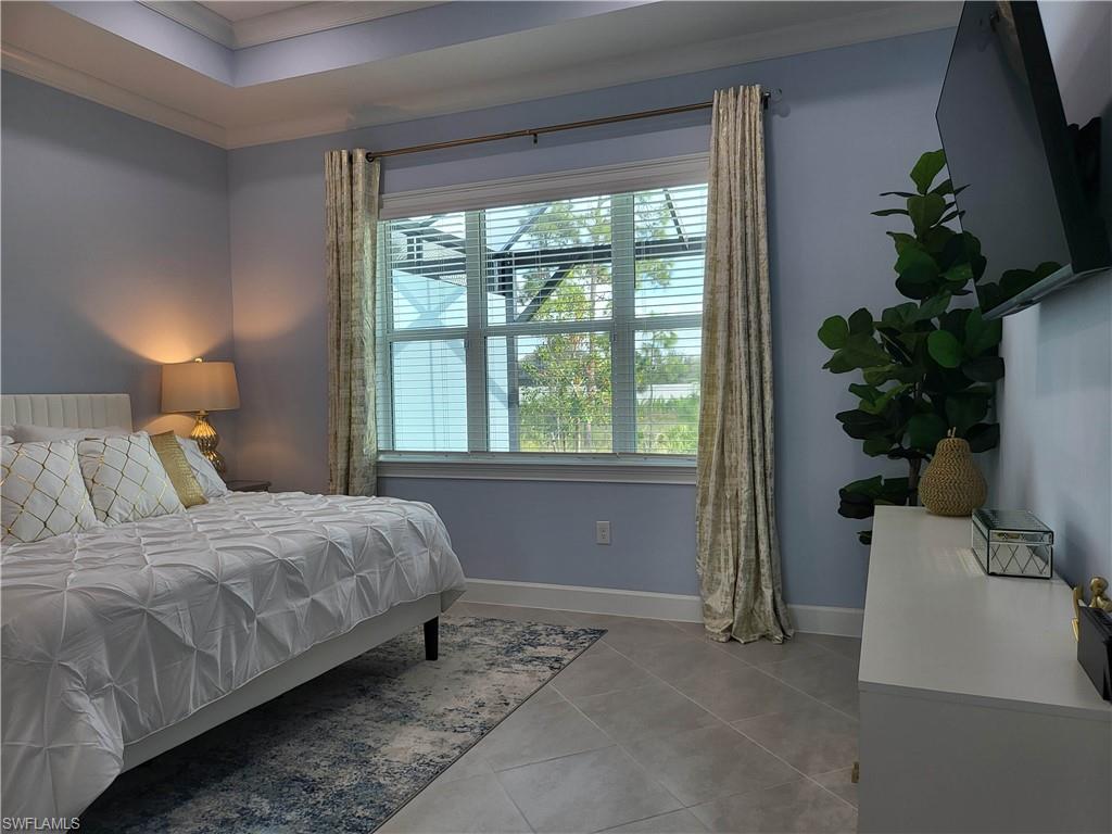 8920 Calypso Court Naples, FL 34113 - Photo 10 of 41 a bedroom with a bed and a window