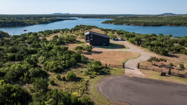 an aerial view of a houses with ocean view