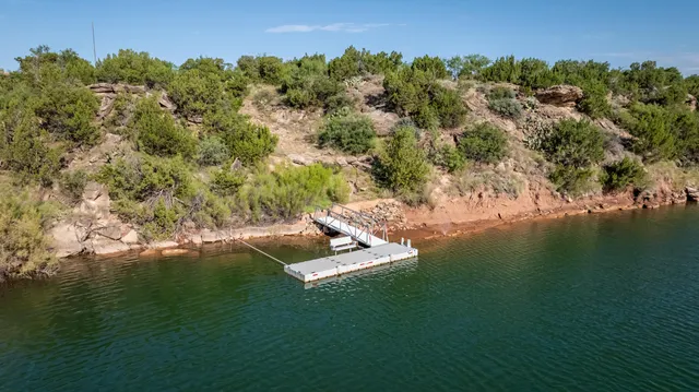 a living room with furniture fireplace and a large window