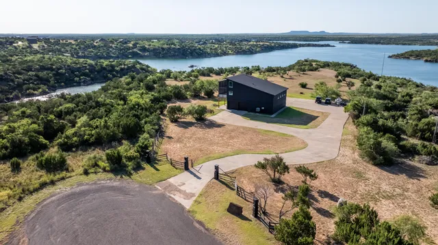 an aerial view of residential houses with outdoor space and river