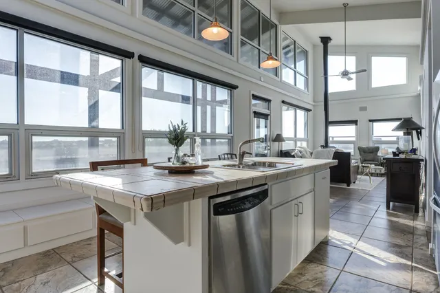 a view of a patio with a table chairs and a barbeque