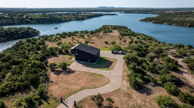 an aerial view of a houses with a lake view