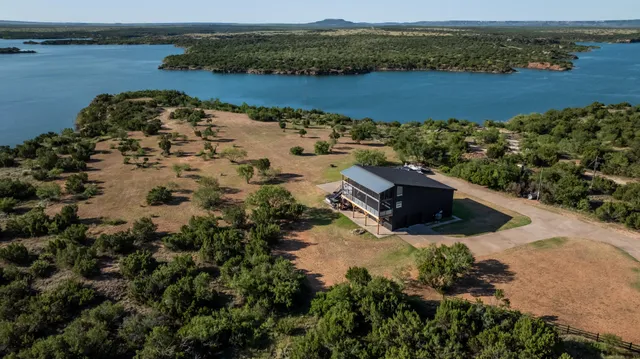 an aerial view of ocean with residential houses with outdoor space