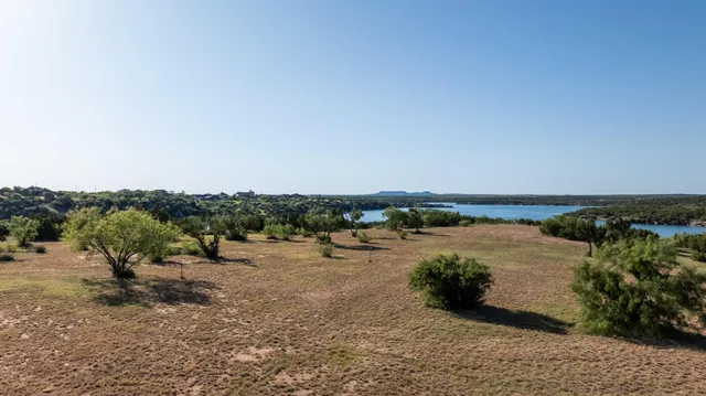 a view of a lake with houses in the back