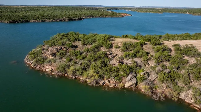 an aerial view of residential houses with outdoor space and river