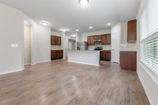 a view of kitchen with kitchen island microwave and stove