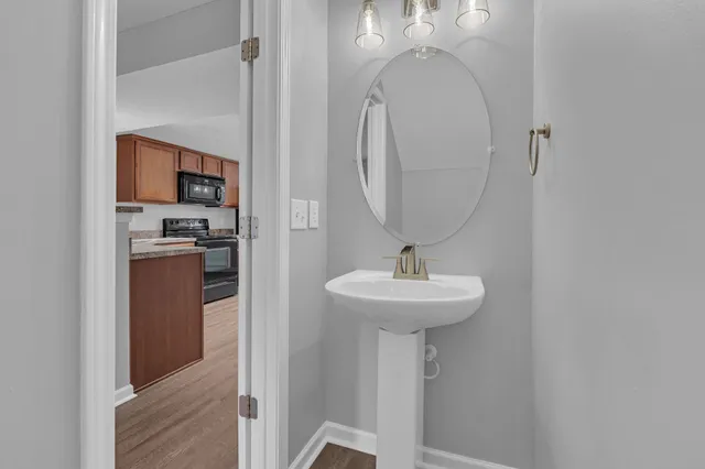 a bathroom with a sink a mirror and vanity