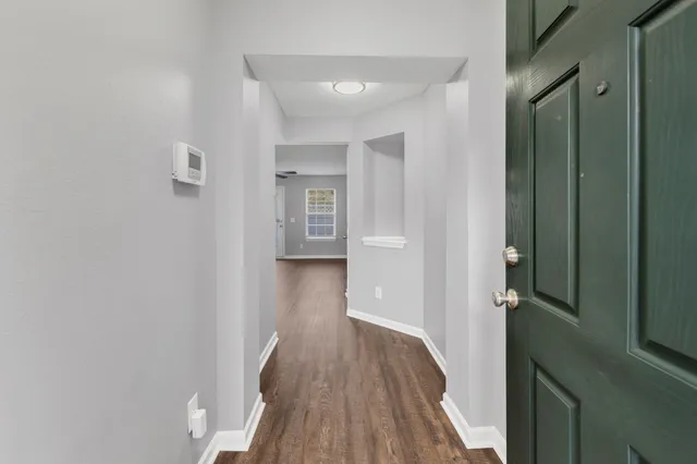 a view of hallway with wooden floor