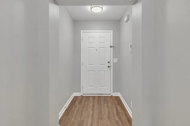 a view of a small space with wooden floor and closet