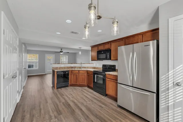 a kitchen with stainless steel appliances a refrigerator sink and microwave