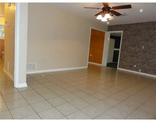 a view of an empty room with a ceiling fan