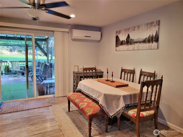 a dining room with furniture and wooden floor