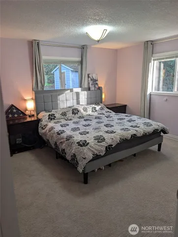 a bedroom with bed and window