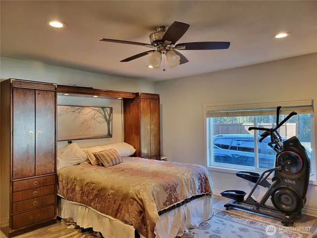 a bedroom with a bed and a ceiling fan