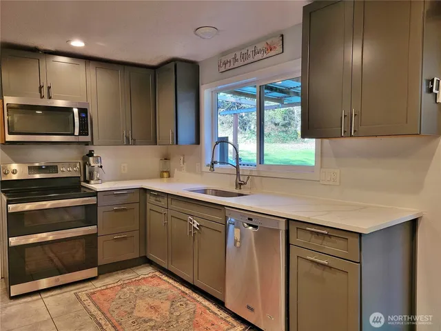 a kitchen with a sink stove and microwave