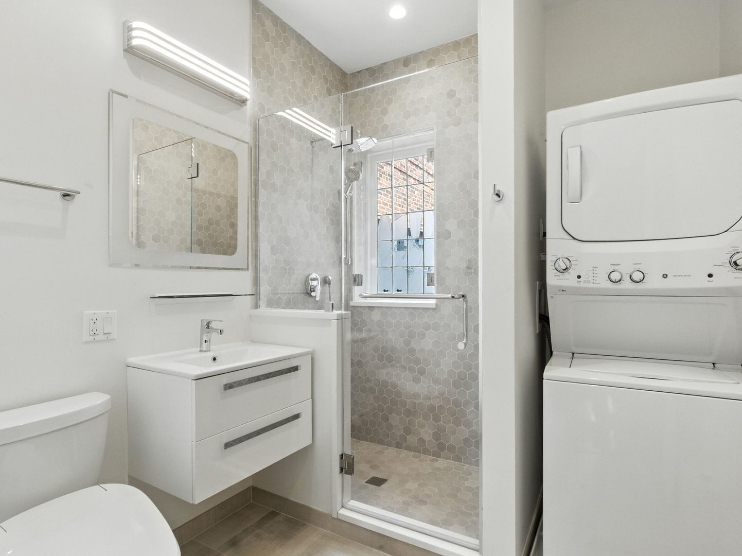 1368 East 57th Street, Unit 3 Chicago, IL 60637 - Photo 11 of 12 a bathroom with a toilet sink and mirror