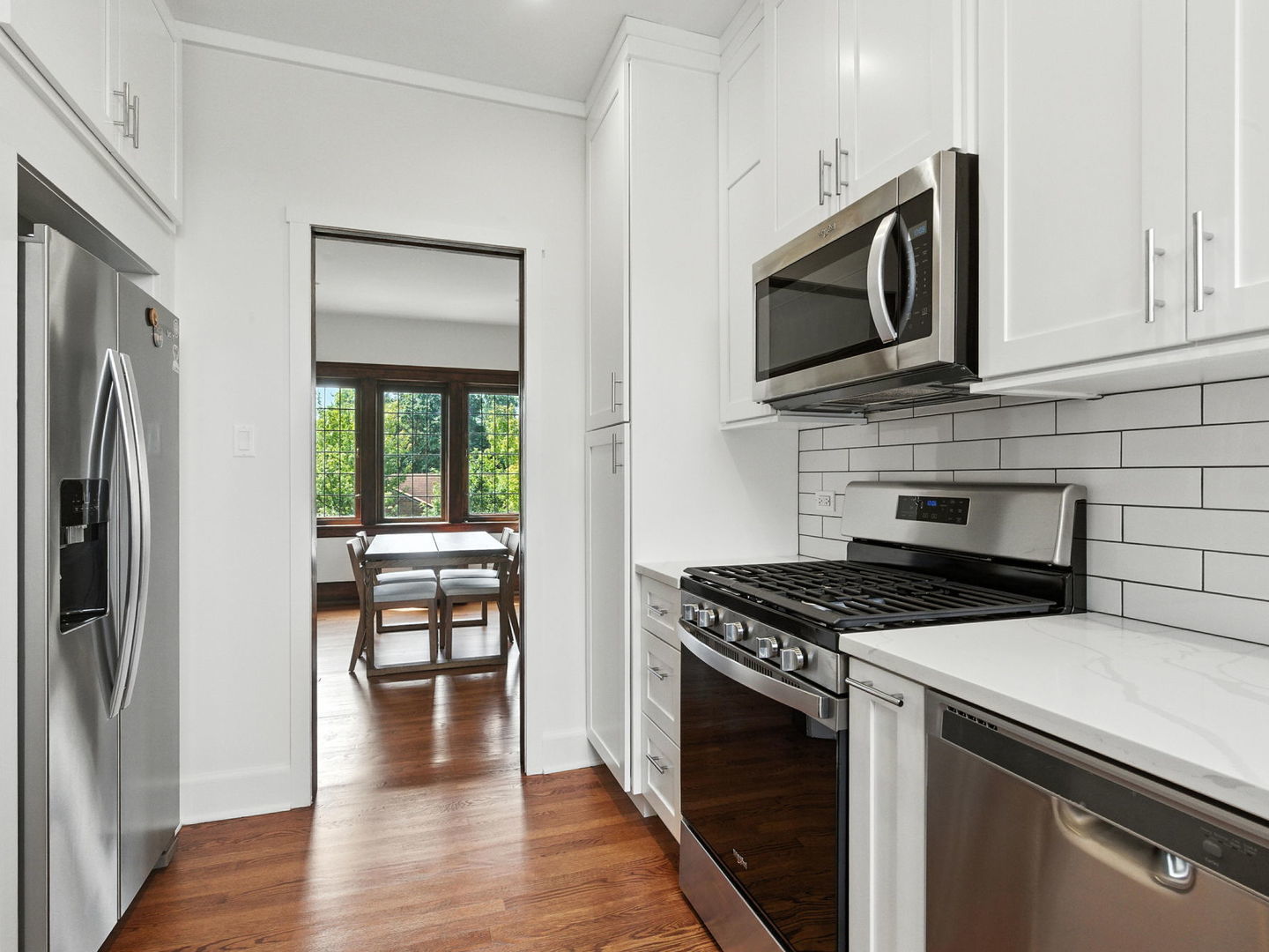 1368 East 57th Street, Unit 3 Chicago, IL 60637 - Photo 7 of 12 a kitchen with stainless steel appliances a stove microwave and sink
