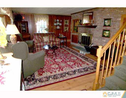 325 Chain O' Hills Road Colonia, NJ 07067 - Photo 2 of 10 a living room with furniture and a flat screen tv