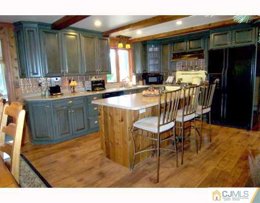 325 Chain O' Hills Road Colonia, NJ 07067 - Photo 4 of 10 a dining area with furniture and kitchen view
