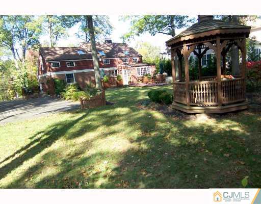 325 Chain O' Hills Road Colonia, NJ 07067 - Photo 10 of 10 a view of a porch with a bench in patio