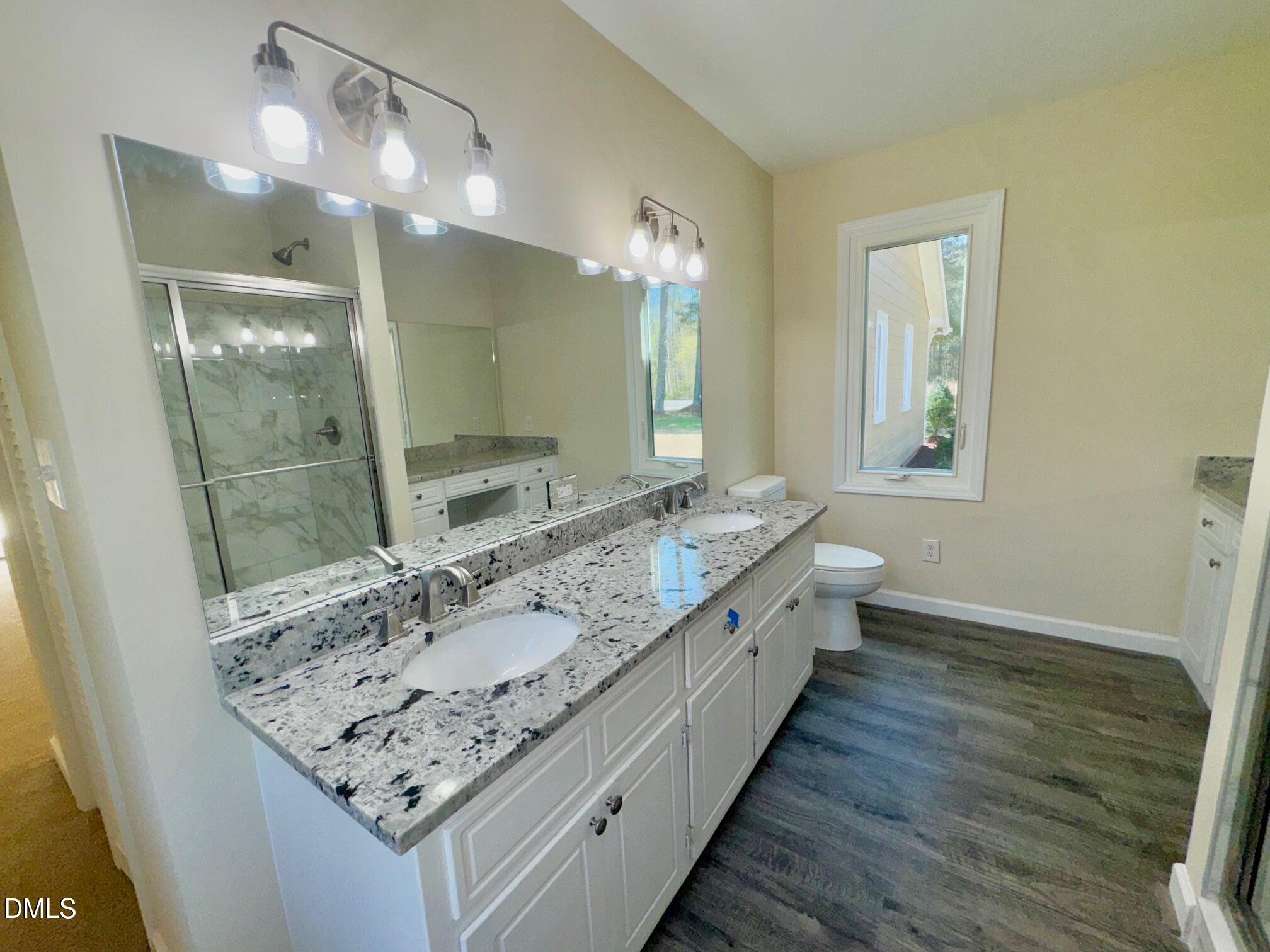 1720 Ross Mill Road Henderson, NC 27537 - Photo 24 of 42 a bathroom with a double vanity sink and a mirror