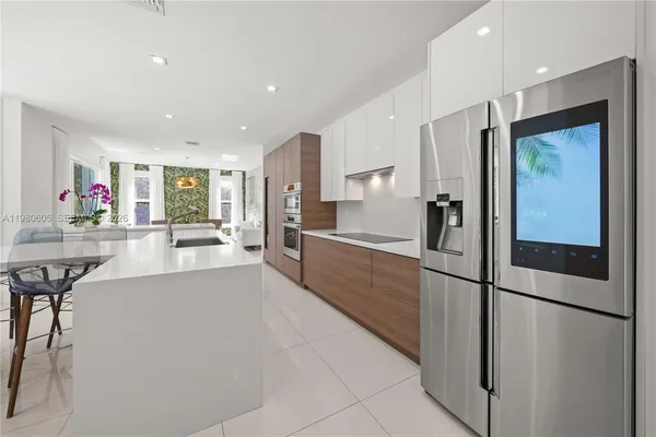 a large white kitchen with a large window