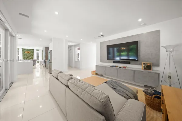 a spacious bedroom with a bed and a flat screen tv