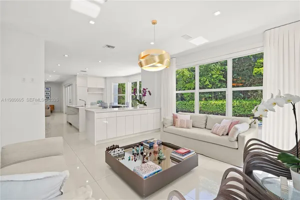 a kitchen with granite countertop a refrigerator and a sink