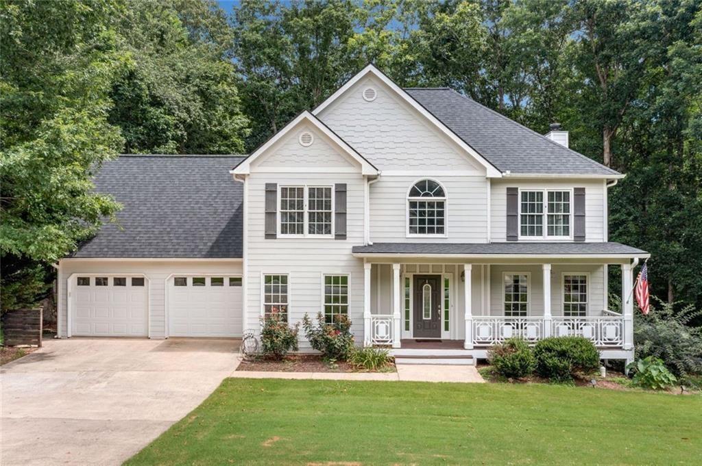 a front view of a house with a yard and porch