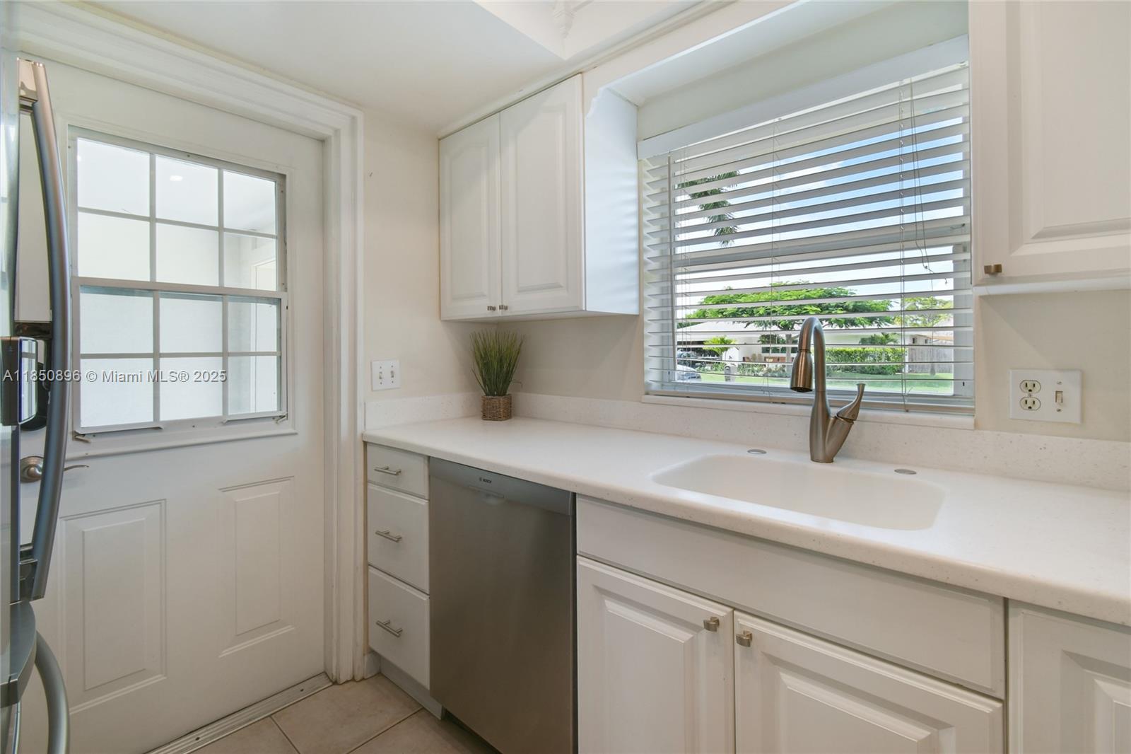 110 Windsor Road East Jupiter, FL 33469 - Photo 14 of 30 a kitchen with appliances cabinets and a sink