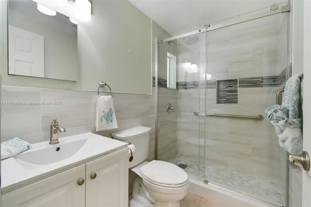 a bathroom with a sink toilet and shower