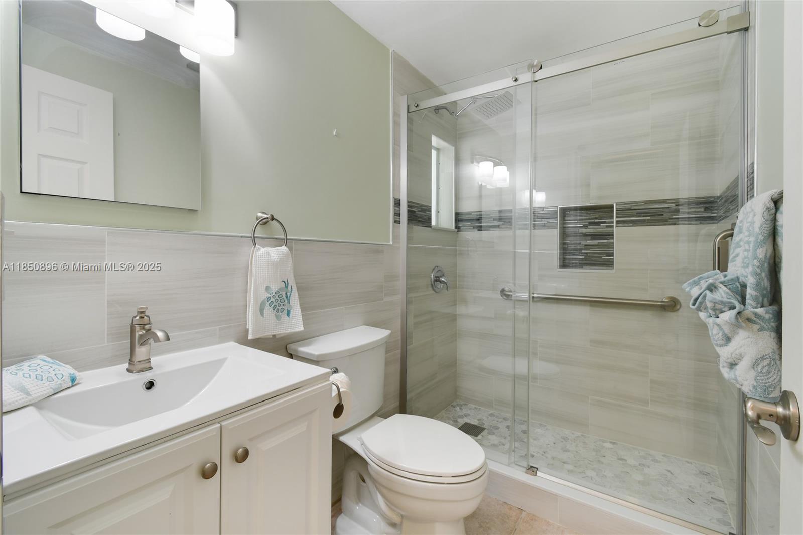 110 Windsor Road East Jupiter, FL 33469 - Photo 19 of 30 a bathroom with a sink toilet and shower