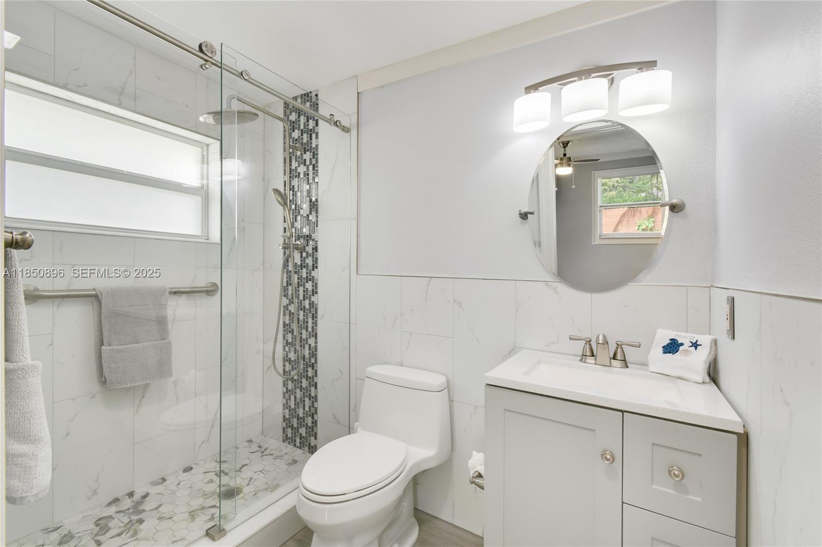110 Windsor Road East Jupiter, FL 33469 - Photo 24 of 30 a bathroom with a sink toilet and shower