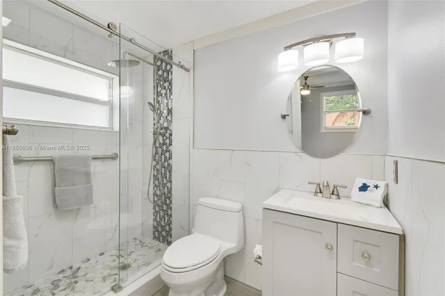 a bathroom with a sink toilet and shower