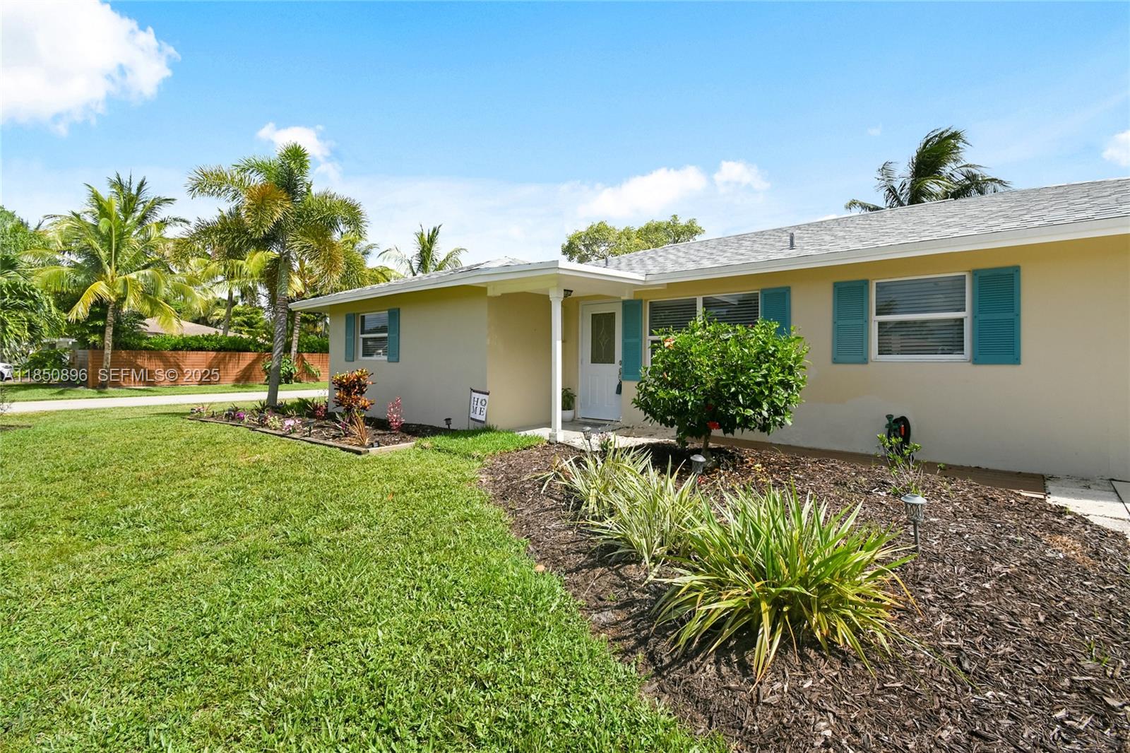110 Windsor Road East Jupiter, FL 33469 - Photo 7 of 30 a front view of a house with a yard