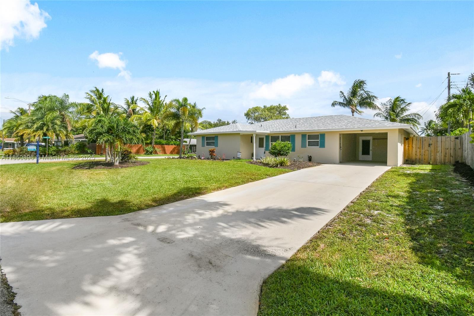 110 Windsor Road East Jupiter, FL 33469 - Photo 8 of 30 a view of a white house with a big yard and potted plants