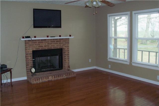 408 Murrell Road Dickson, TN 37055 - Photo 5 of 19 Living room has nice hardwood flooring and a brick fireplace.