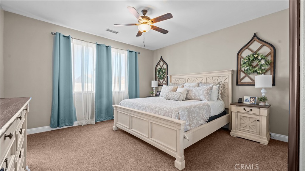 11780 Poppy Road Adelanto, CA 92301 - Photo 21 of 35 a bed room with a bed and a window
