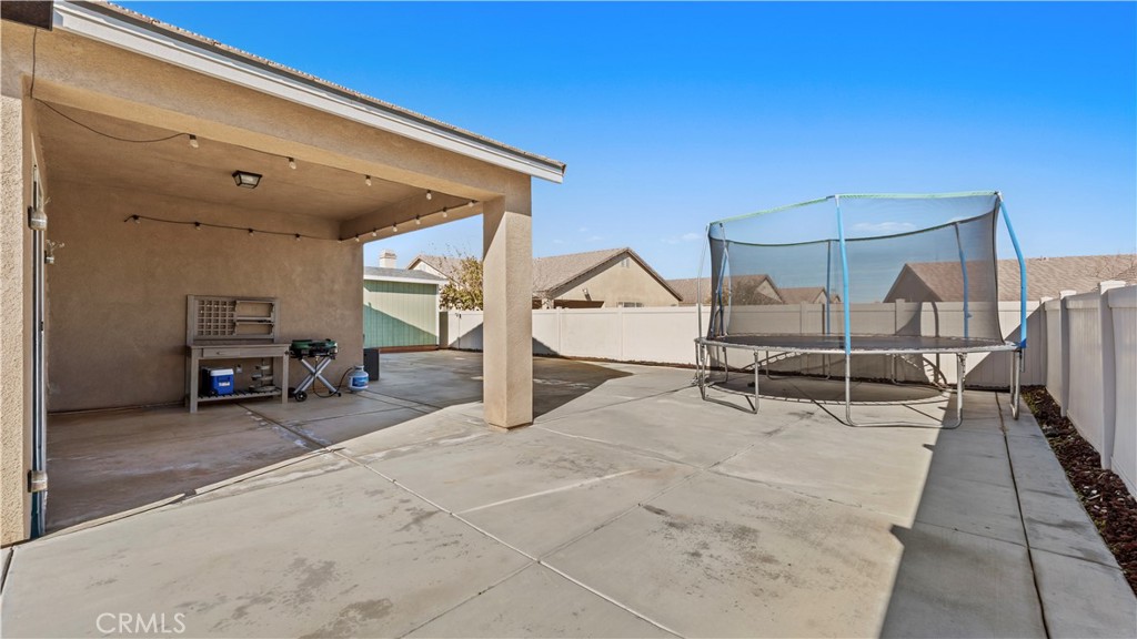 11780 Poppy Road Adelanto, CA 92301 - Photo 25 of 35 a view of a big room with wooden floor and furniture