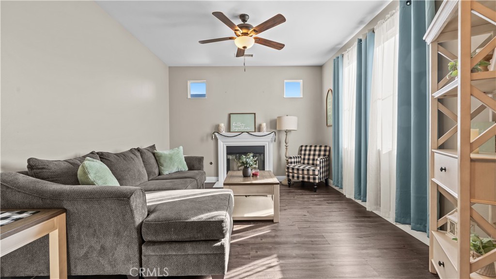 11780 Poppy Road Adelanto, CA 92301 - Photo 4 of 35 a living room with furniture and a fireplace