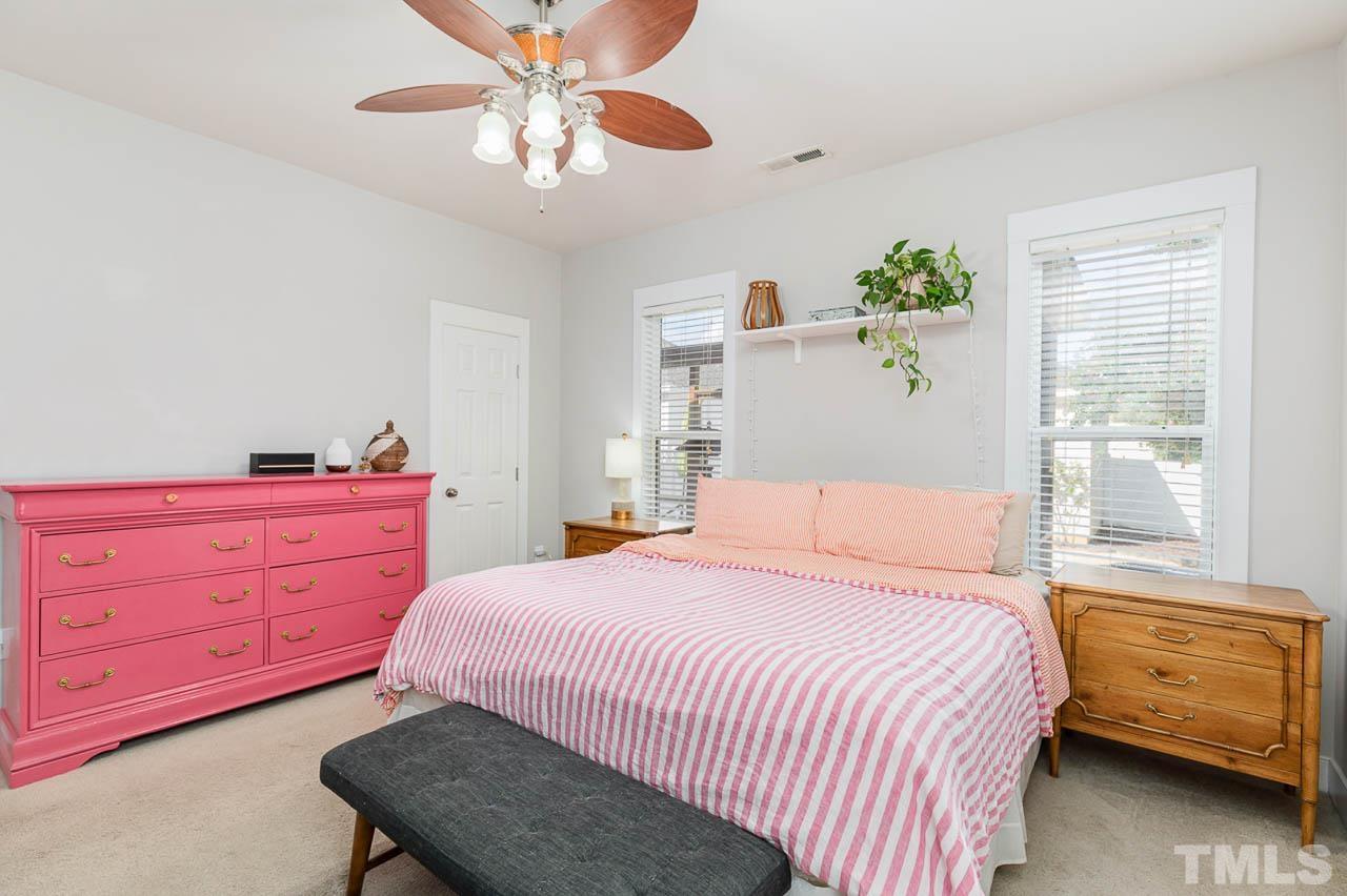 2813 Falls River Avenue Raleigh, NC 27614 - Photo 11 of 28 a bedroom with a bed and a dresser