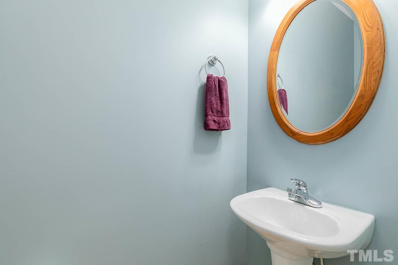 2813 Falls River Avenue Raleigh, NC 27614 - Photo 14 of 28 a bathroom with a sink and a mirror