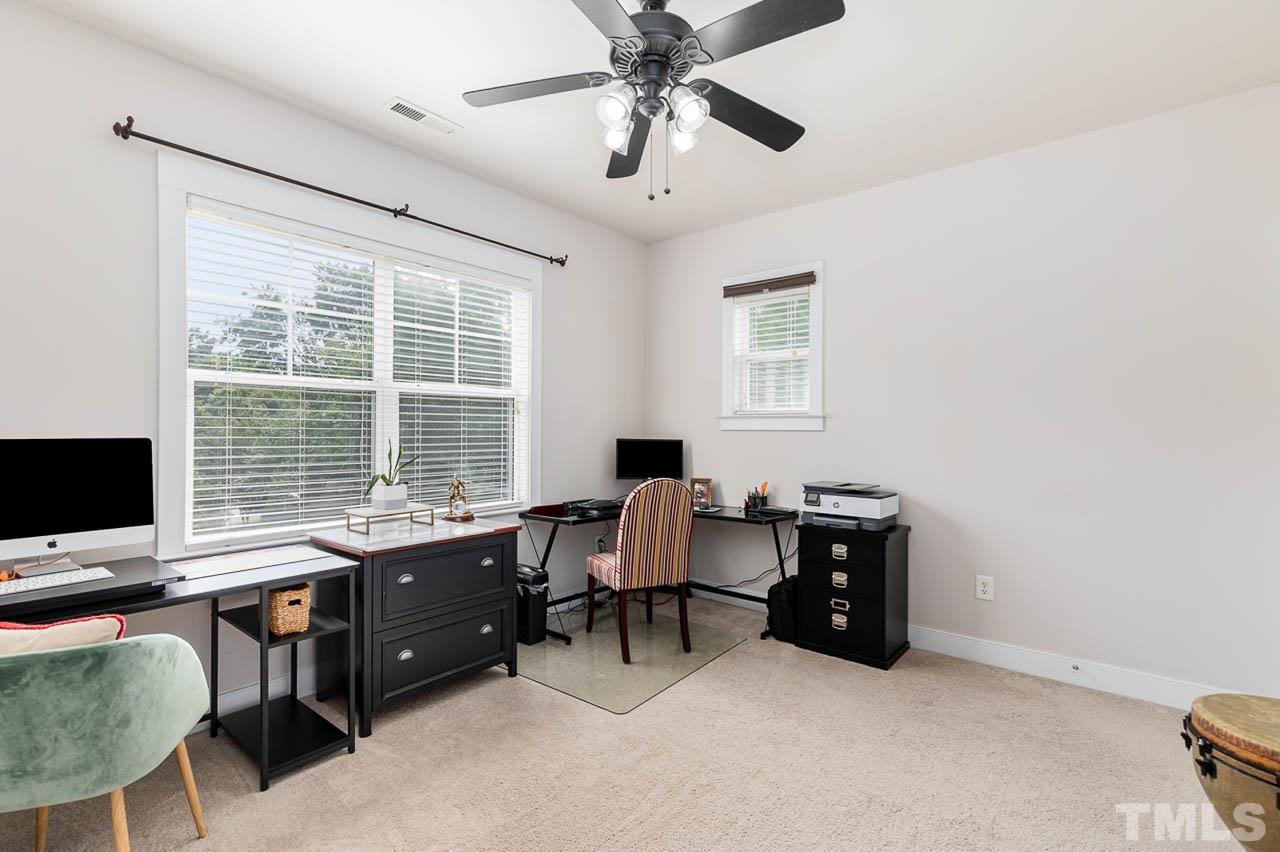 2813 Falls River Avenue Raleigh, NC 27614 - Photo 16 of 28 a view of a workspace with furniture and a window