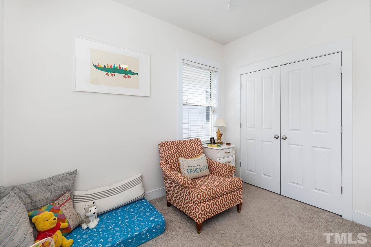 2813 Falls River Avenue Raleigh, NC 27614 - Photo 18 of 28 a living room with furniture and a rug