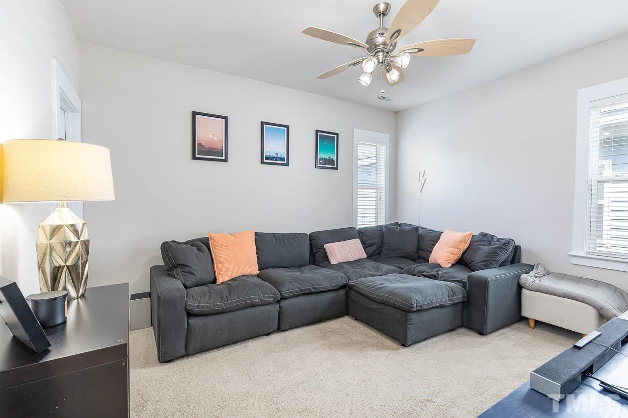 2813 Falls River Avenue Raleigh, NC 27614 - Photo 19 of 28 a living room with furniture a couch and a window