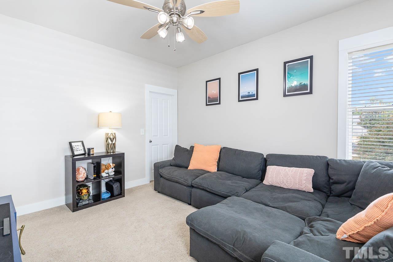 2813 Falls River Avenue Raleigh, NC 27614 - Photo 20 of 28 a living room with furniture and a flat screen tv